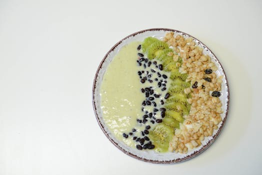 a vibrant smoothie bowl topped with fruits and seeds